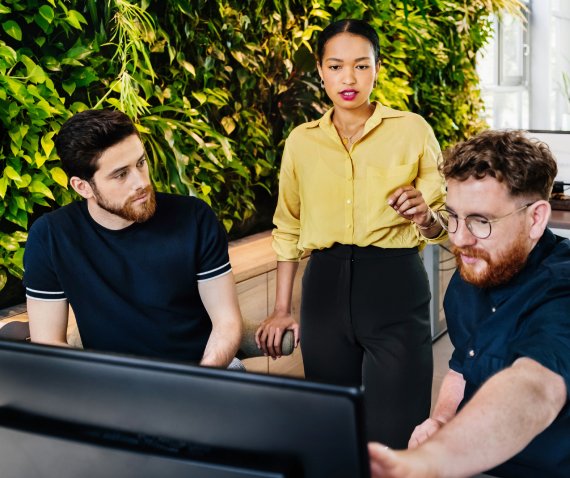 Three coworkers in discussion