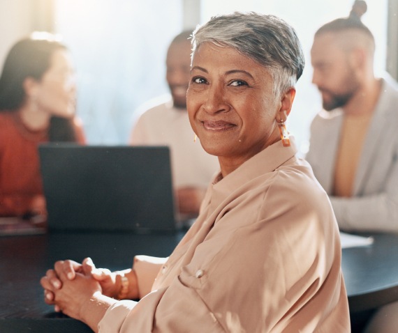 Smiling woman in workplace meeting