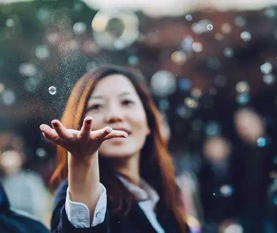 women playing with bubbles