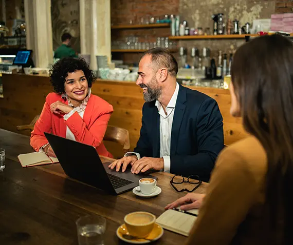 three coworkers meeting at coffee shop